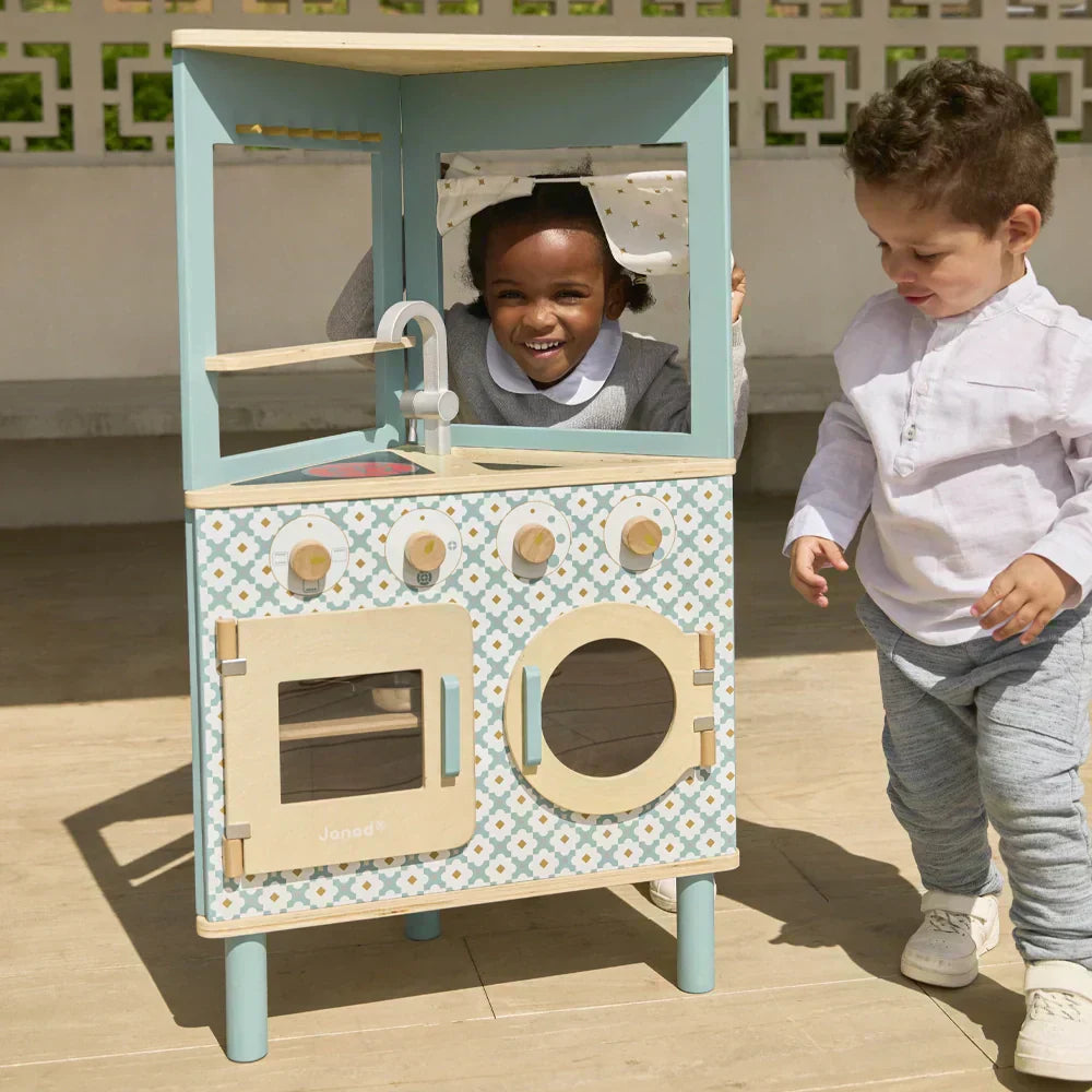 Two Toddlers with play with the janod trio play kitchen.