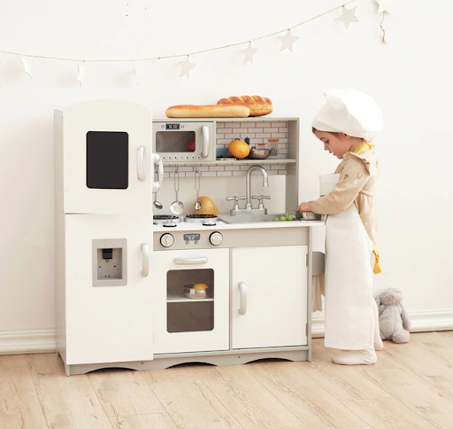 Kids play in the best grey wooden toy kitchen, which comes with 10 utensils.