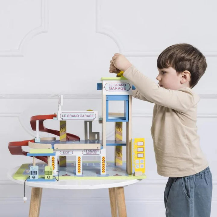 Boy playing with toy garage