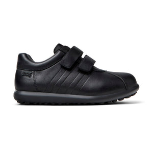 Side view of Camper Pelotas black leather shoes for kids, showcasing the durable leather upper and the convenient hook-and-loop straps for easy fastening.