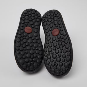 The shoes' design ensures extra toe protection and a sturdy rubber outsole for active children.