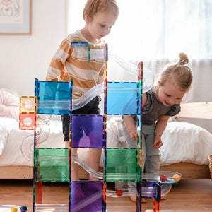 Kids enjoying building a ball run with Connetix tiles