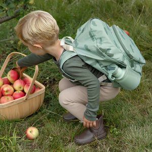 A child is having fun with done by dear backpack.