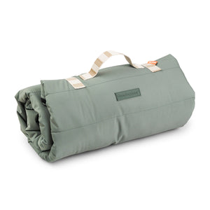 Rolled-up green sleeping bag with carry handle.