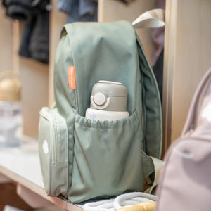 Two side pockets with elastic band to fit a bottle.