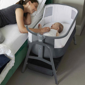 Parent reaching into Bubba&Me crib to comfort baby