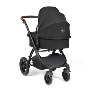 Back view of Ickle Bubba pushchair with carry cot in a white background,