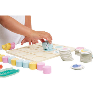 A child placing a snail shell on the correct spot, improving spatial awareness.
