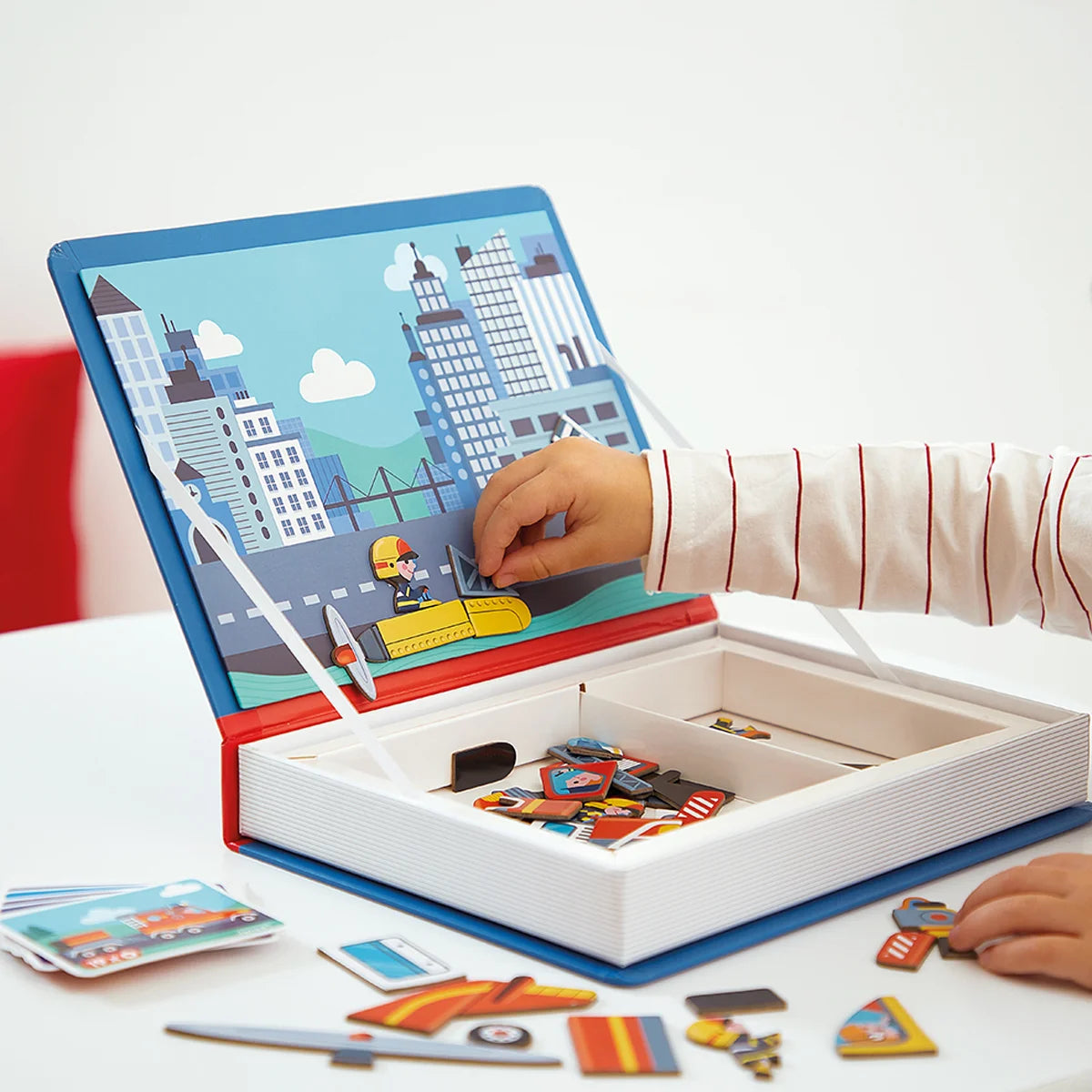 Child exploring the world of firefighting with magneti book