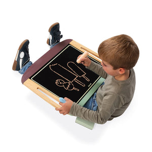 Child drawing on the Janod black chalkboard side of the blackboard table
