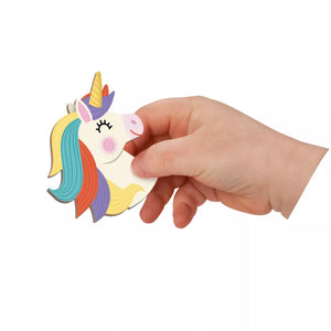Child’s hand placing unicorn magnetic piece onto Janod Magnetibook play surface