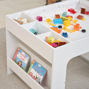 An activity table with colourful toys and books scattered across the surface creates a fun and inviting play space.