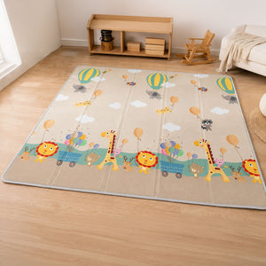 A large, multi-panel baby play mat with a whimsical safari-themed design, laid out on a light wood floor in a styled nursery room.