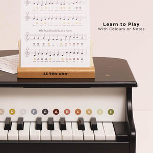Wooden grand piano with music stand.