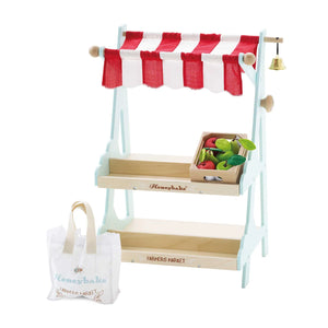 Le Toy Van wooden market stall with a shopping bag in a white background.