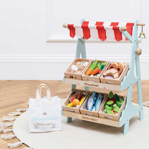 Le Toy Van wooden market stall with different foods and vegetables crate.