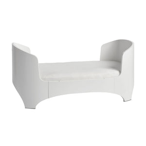 Oval wooden baby bed made from molded beech wood.