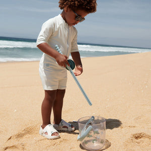 A boy is catching crabs using a Lywood crab rod set.