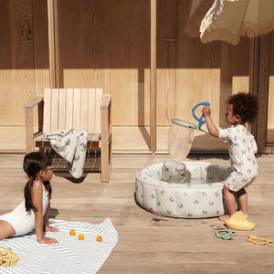 Children are enjoying splash time in the paddling pool.