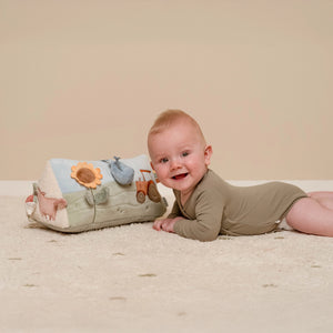 baby playing with colorful little dutch activity triangle.
