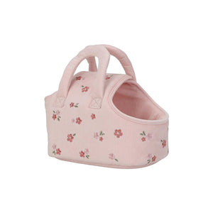Pink pet carrier with floral pattern on a white background