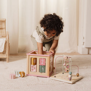 Toddler interacting with Little Dutch wooden activity cube at playtime