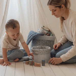 A boy and his mother are playing with the Little Dutch wooden blocks.