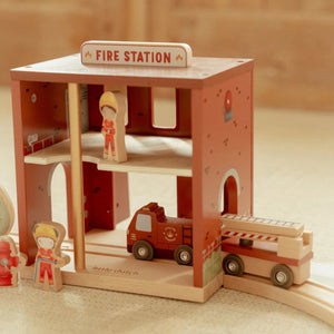 Fire station doors open with fire truck ready to go.