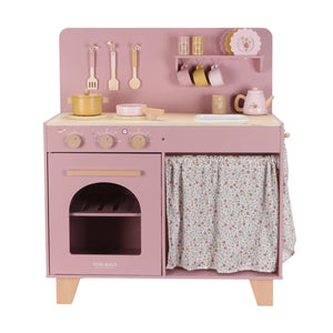 Pink toy kitchen set with various accessories on a white background