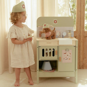 Green wooden vet clinic setup for imaginative pet care.