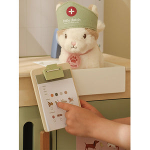 Little hands playing with accessories in the veterinary practice set.