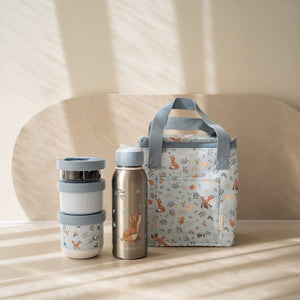 Blue Little Dutch Forest Friends cooler bag sitting next to a matching Mepal water bottle and food jar.