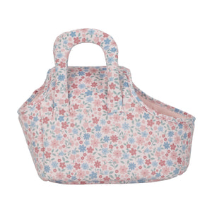 A side-angle view of the empty floral print carry bag, highlighting its curved design and stitched fabric handles.