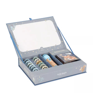 A baby gift set from 'little dutch' in a decorative blue-gray box with a large mirror on the inside lid. The set includes a tube of lotion, a small book or booklet, and several round pacifiers with printed animal faces.