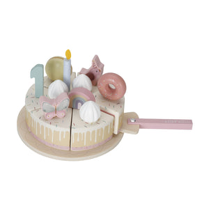 The pink Little Dutch wooden birthday cake on a white background with one slice being pulled away by the wooden cake server.