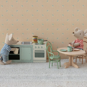 Maileg miniature kitchen set displayed with soft toys.