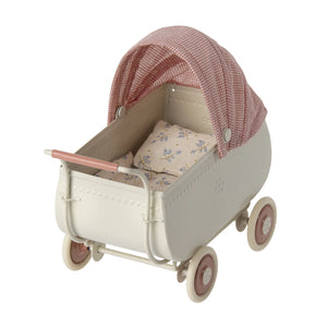 A close-up of the Maileg micro pram showcasing its classic old-fashioned design and sturdy wheels.