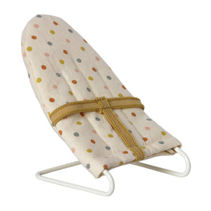 A small, micro-sized, beige baby sitter chair with multicolored dots and a sturdy metal base, designed for toy animals like baby mice and rabbits.