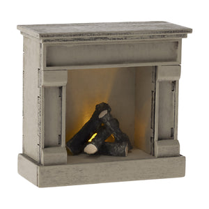 The Maileg fireplace can be turned off and on with the coin cell battery.