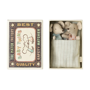Maileg twin baby mice in a matchbox, with one mouse wearing a blue onesie and the other in pink, inside a matchbox with a 'Best Quality' design.