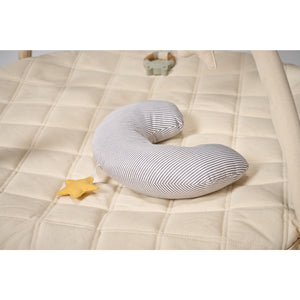 Striped body tummy time pillow on a beige quilt with a yellow star