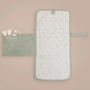 The MiniDream baby changing mat, available in a sage green colour, features an inside design with a pocket.