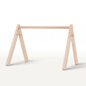 A minimalist light natural wood baby gym frame stand with a horizontal top rail.