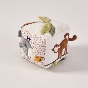 Angled display of the MiniDream soft activity cube highlighting contrasting jungle animal patterns and tactile textures for early playtime.