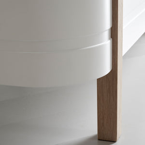 Modern nursery bed with solid oak legs and white frame