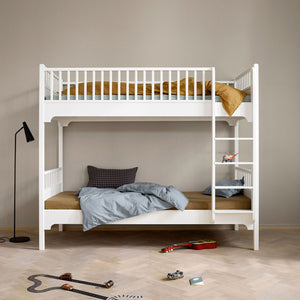 Vertical ladder attached to one side of the bed