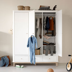 Open wooden wardrobe showing adjustable shelves and hanging rail interior