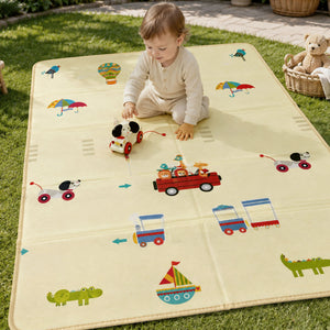 A baby playing happily with a toy on the vehicle-themed side of the Allis Folding Play Mat set up outdoors on a grassy lawn.