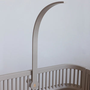 Easy-to-install sebra wooden mobile holder on a playpen or cot.