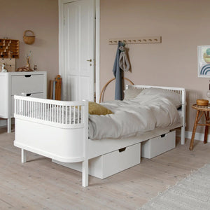 ebra Junior & Grow bed in classic white styled in bright neutral bedroom with soft linen and natural decor